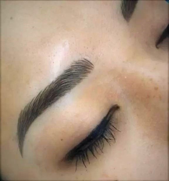 A close up of the eyebrows and eyelashes of a woman
