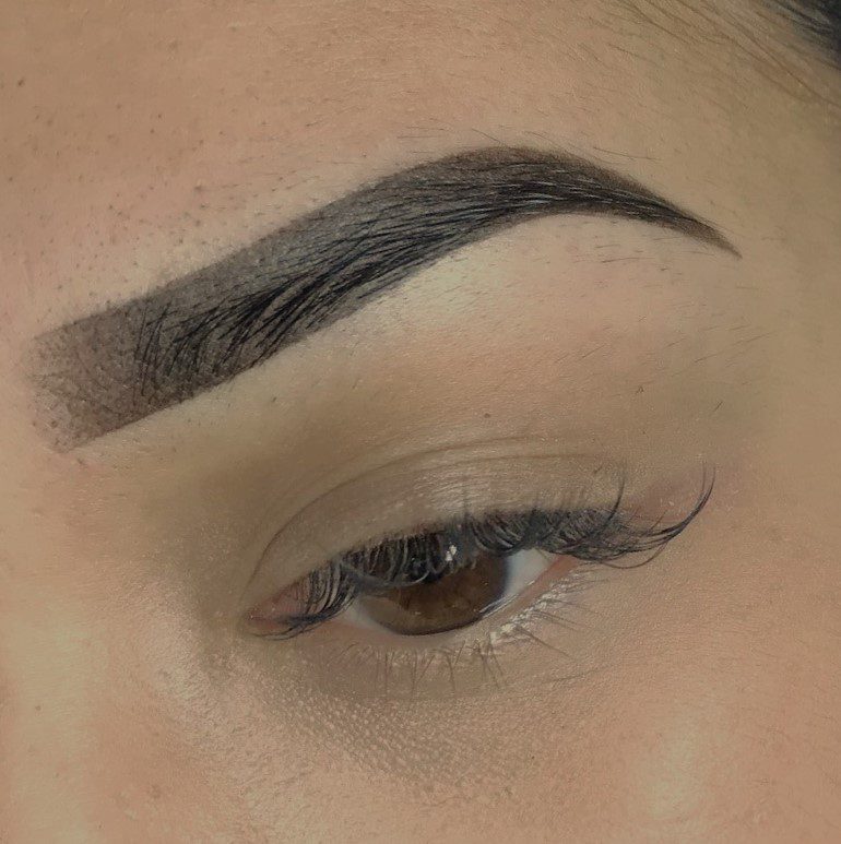 A close up of the eye with brows drawn