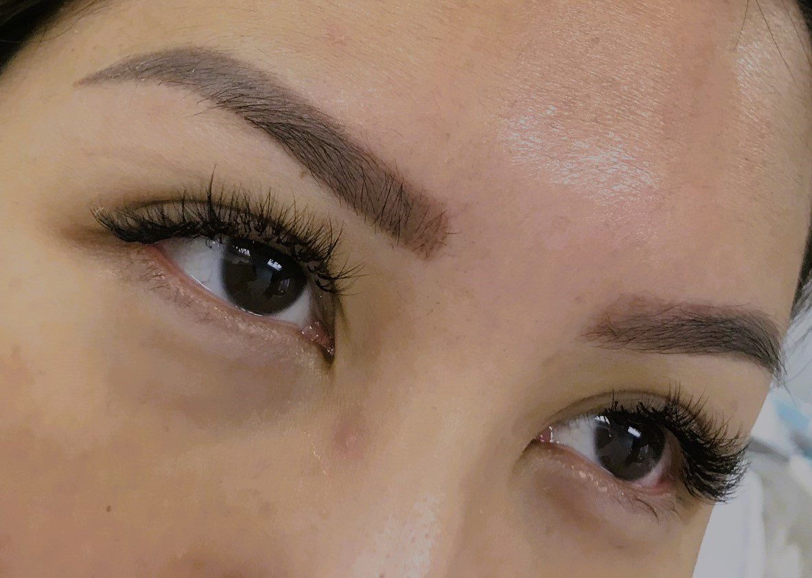 A close up of a person 's eyes with brows