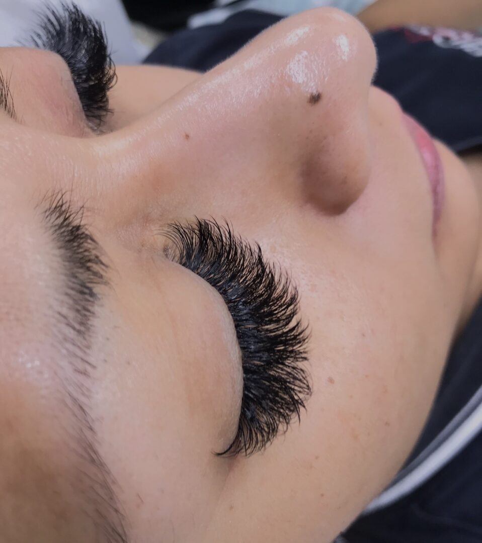 A woman with long eyelashes is laying down