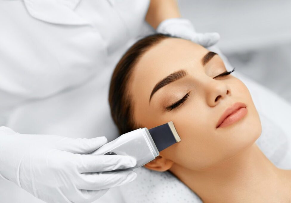 A woman getting her face waxed by an esthetician.